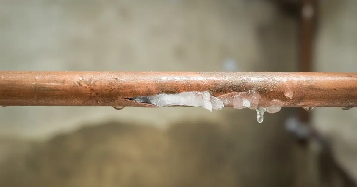 A copper pipe that has frozen solid and burst in the middle.