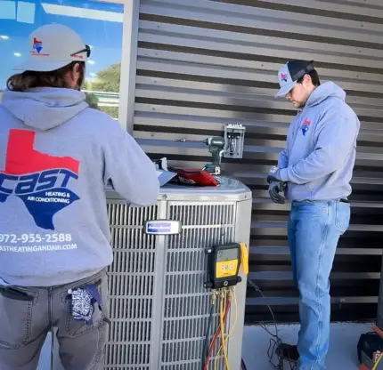 Cast Heating & Air Conditioning technicians working on an AC repair in Combine, TX
